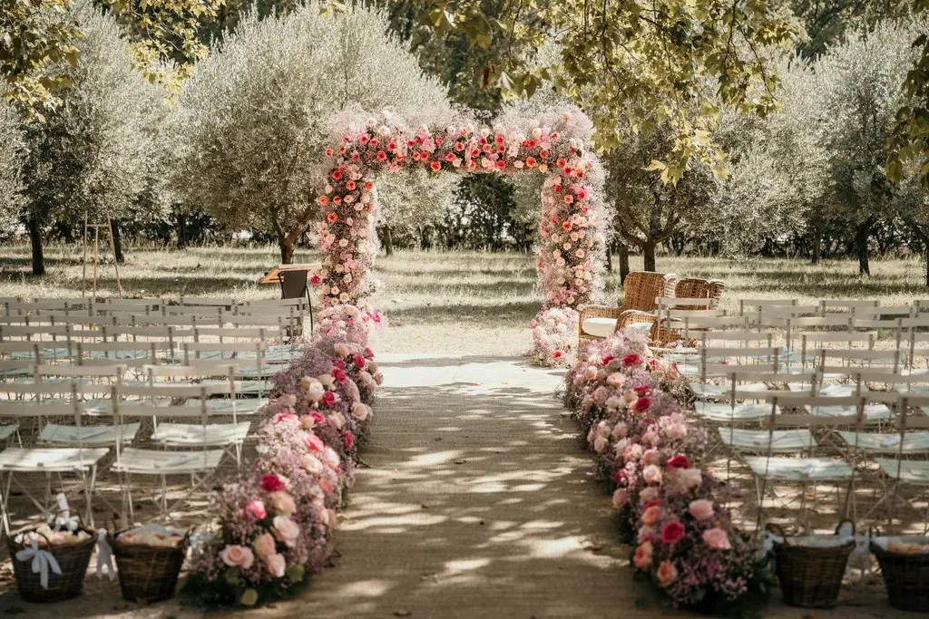 Allée de cérémonie fleurie de roses sous les oliviers