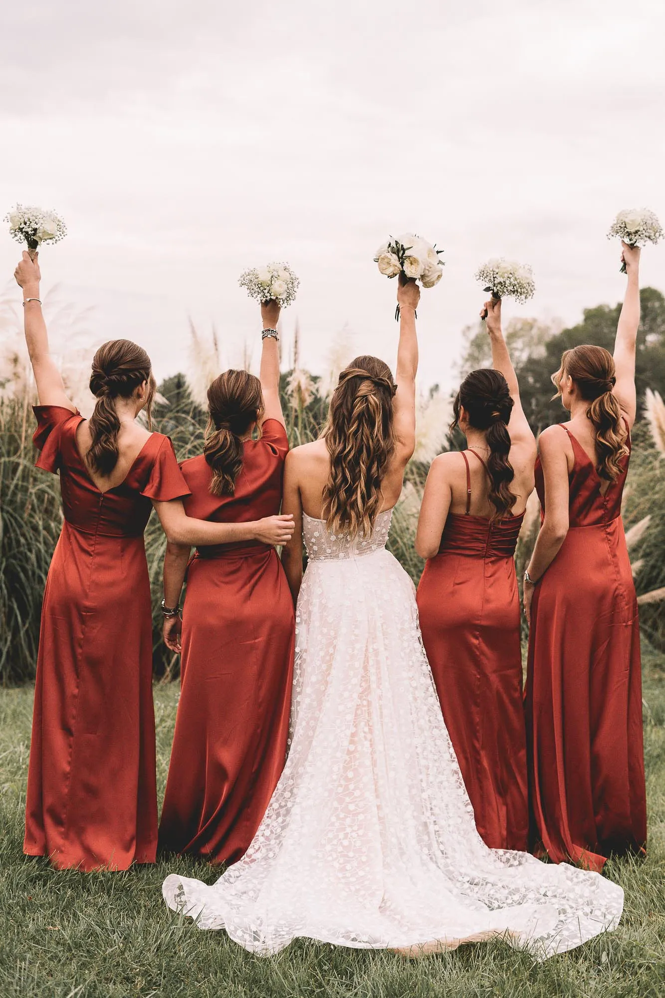 Les demoiselles d’honneur lèvent leurs bouquets au ciel